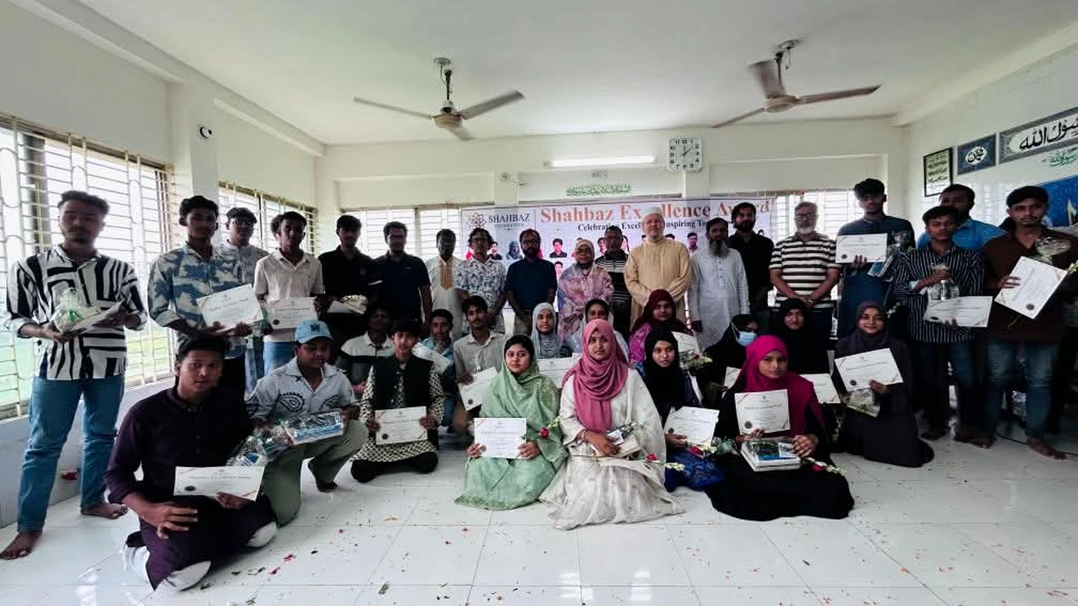 Participants receiving certificates at a Shahbaz Foundation education programme